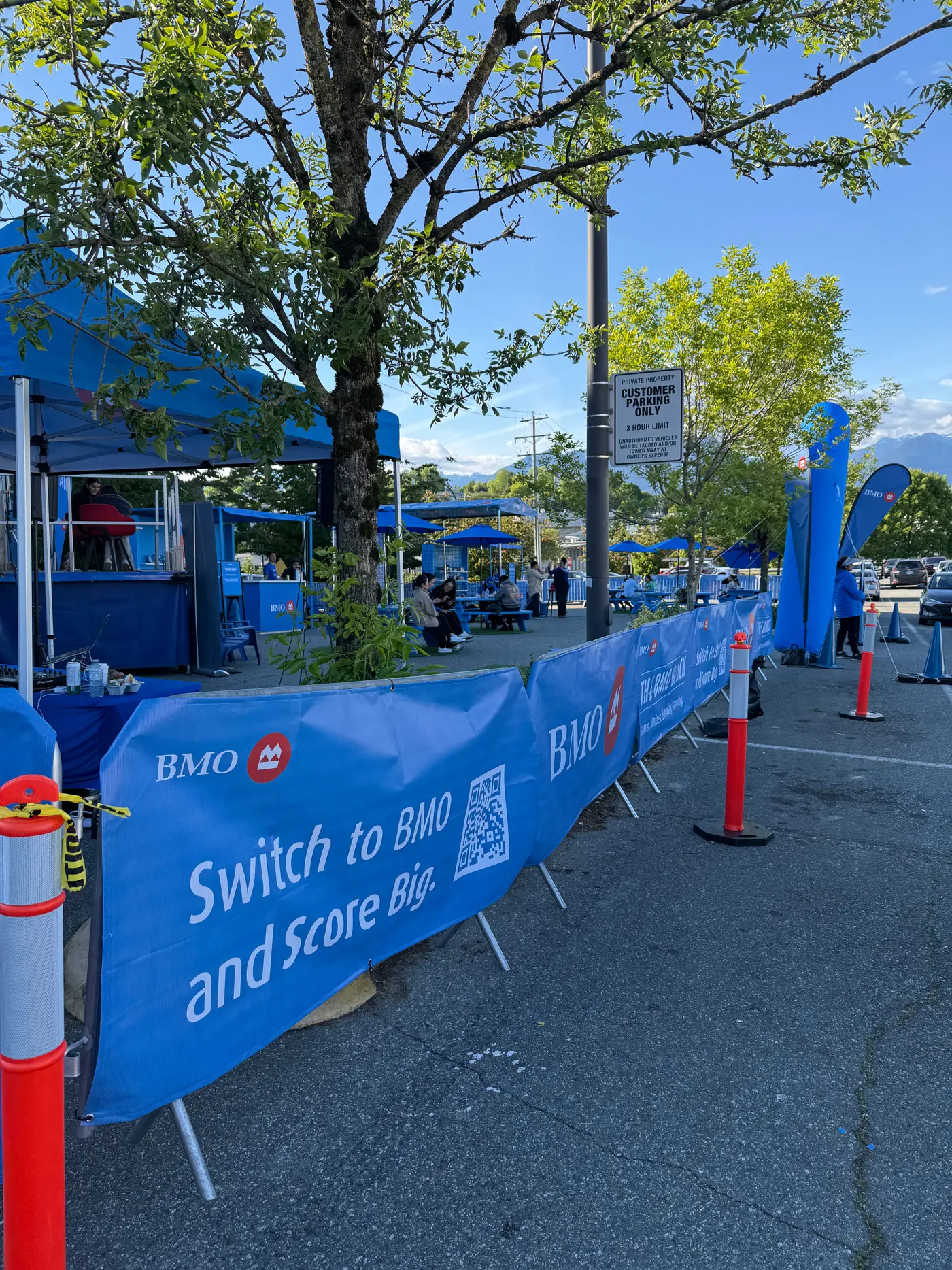 Branded covers on a line of crowd control barriers along a street festival