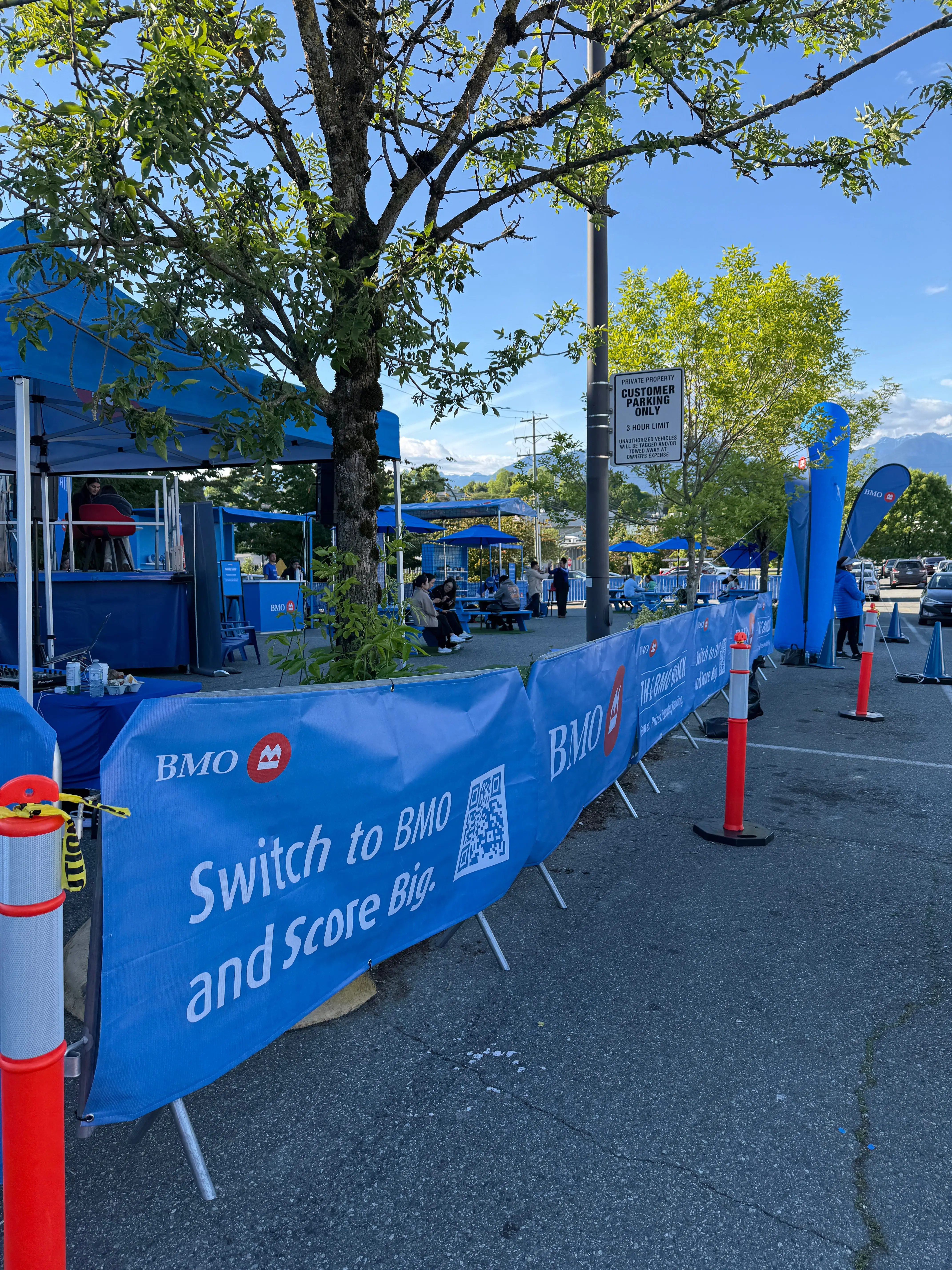 Branded covers on a line of crowd control barriers along a street festival
