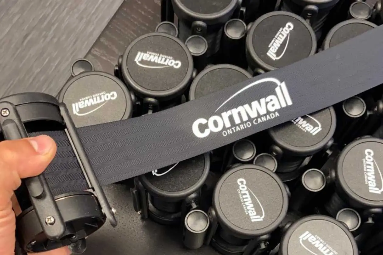 A printed retractable belt drawn out of its cassette by hand