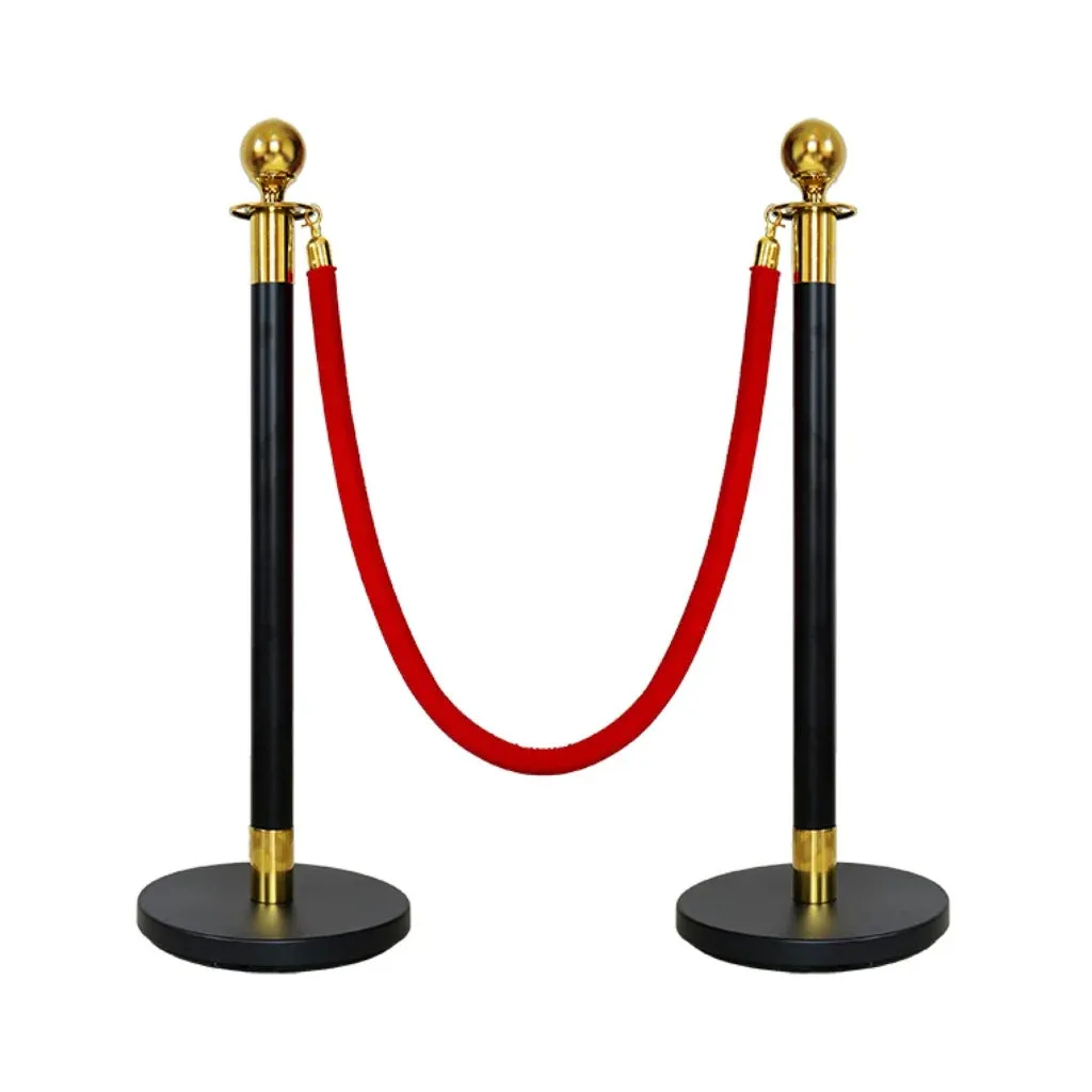 Black rope stanchion posts joined by a red velvet rope
