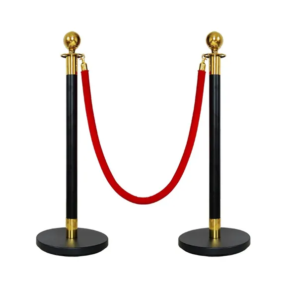 Two black rope stanchion posts joined by a red velvet rope