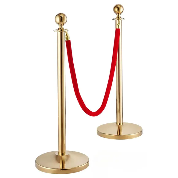 Gold rope stanchion posts with a red velvet rope between them