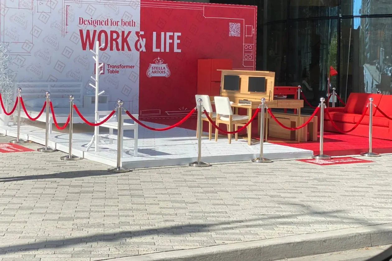 Red velvet ropes on chrome posts around a red carpet display outdoors