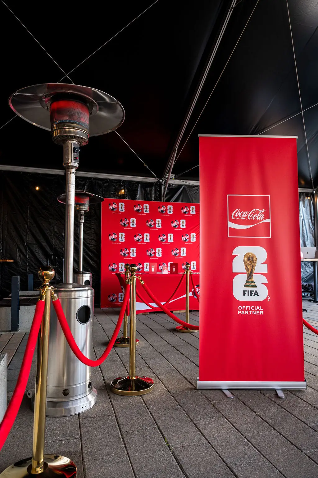Gold rope stanchions with red velvet ropes on a covered outdoor deck