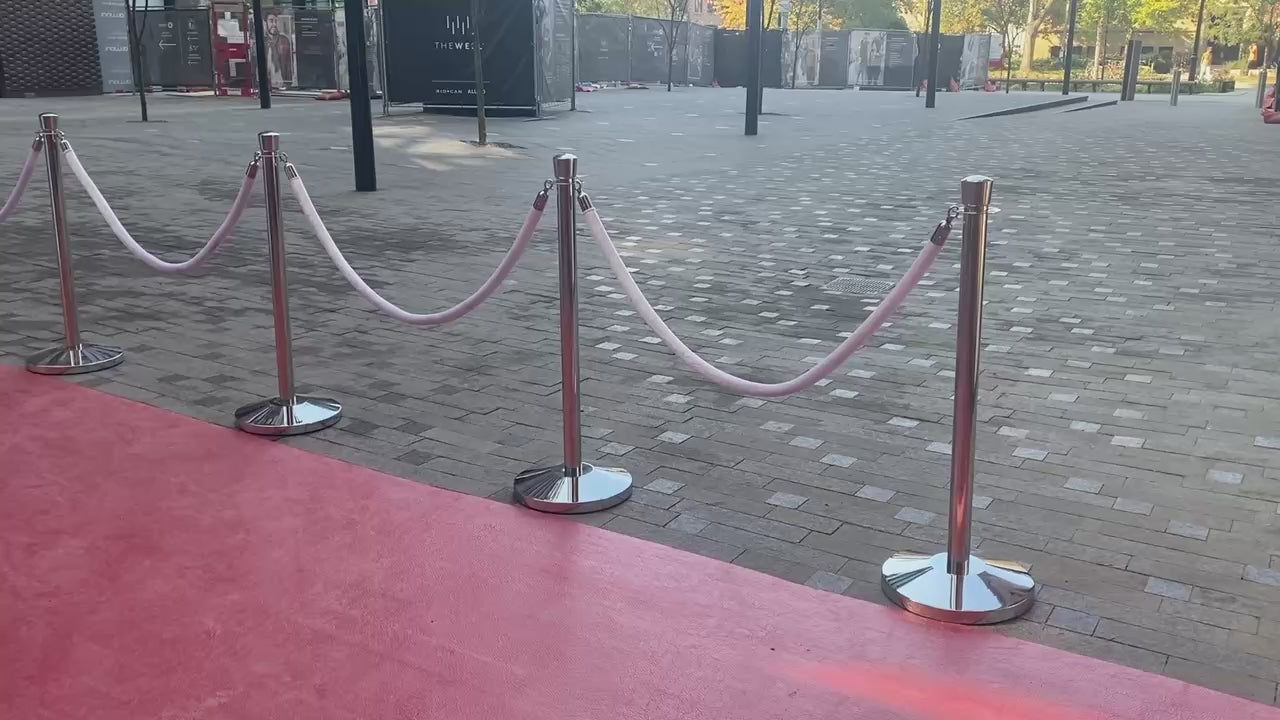 Load video: silver stanchions with white velvet rope
